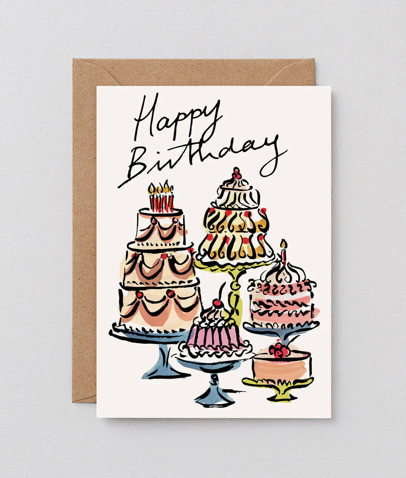 Birthday card with illustrations of cakes and 'Happy Birthday' text on a white background.