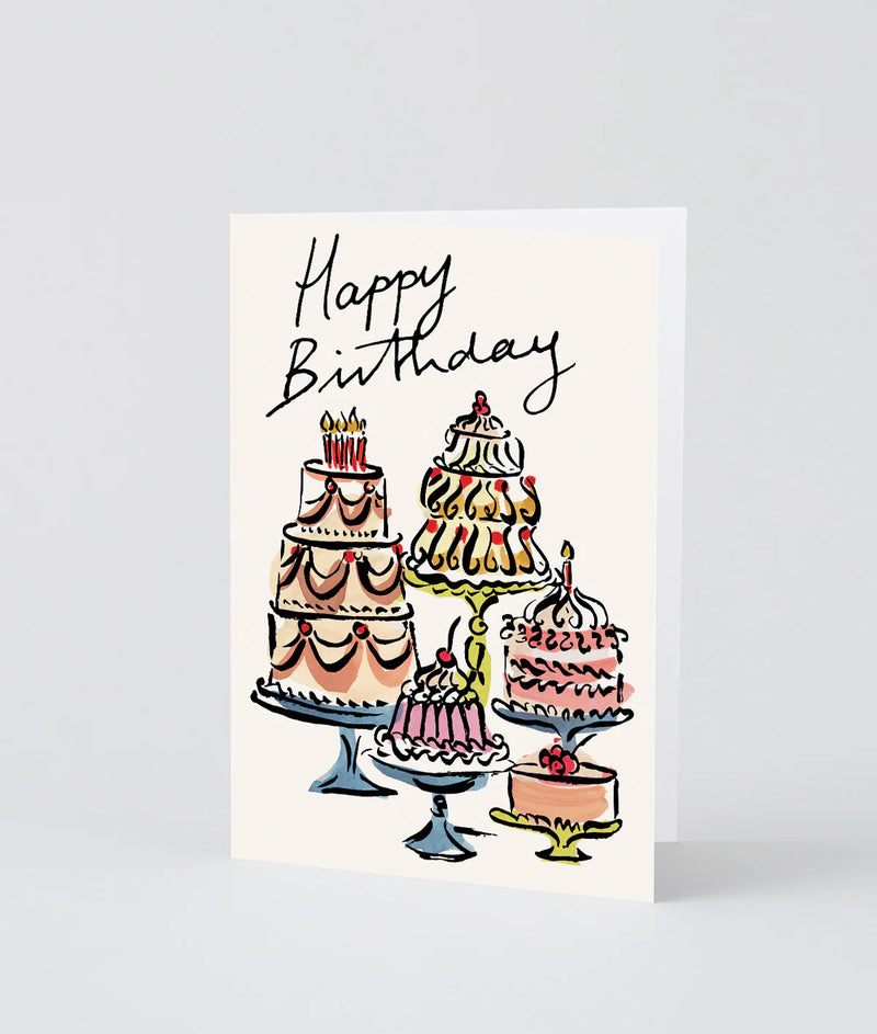 Greeting card with illustrations of cakes and 'Happy Birthday' text on a white background