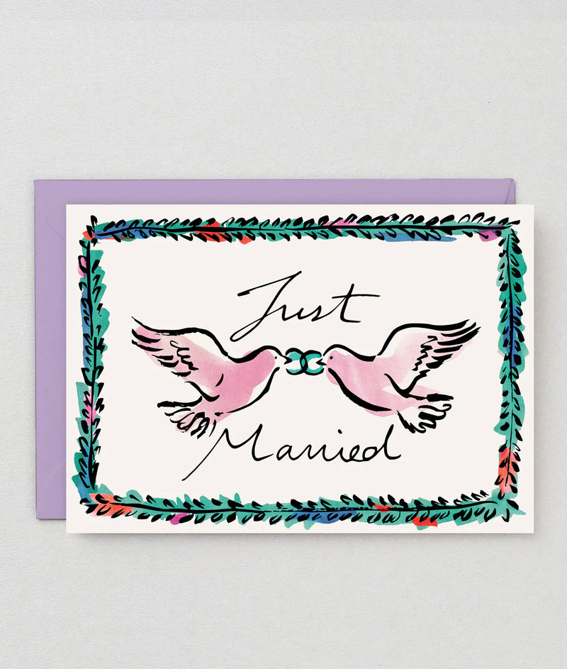 Greeting card with two pink doves holding a blue ribbon and 'Just Married' text on a white background with a purple border.