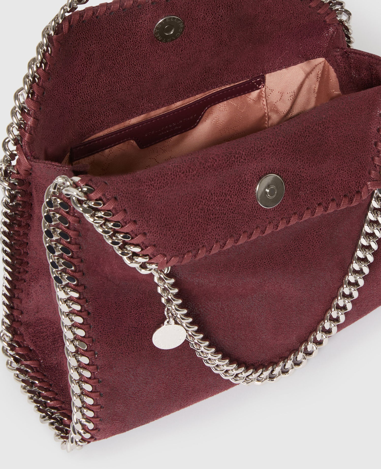 Maroon handbag with silver chain detail on a white background