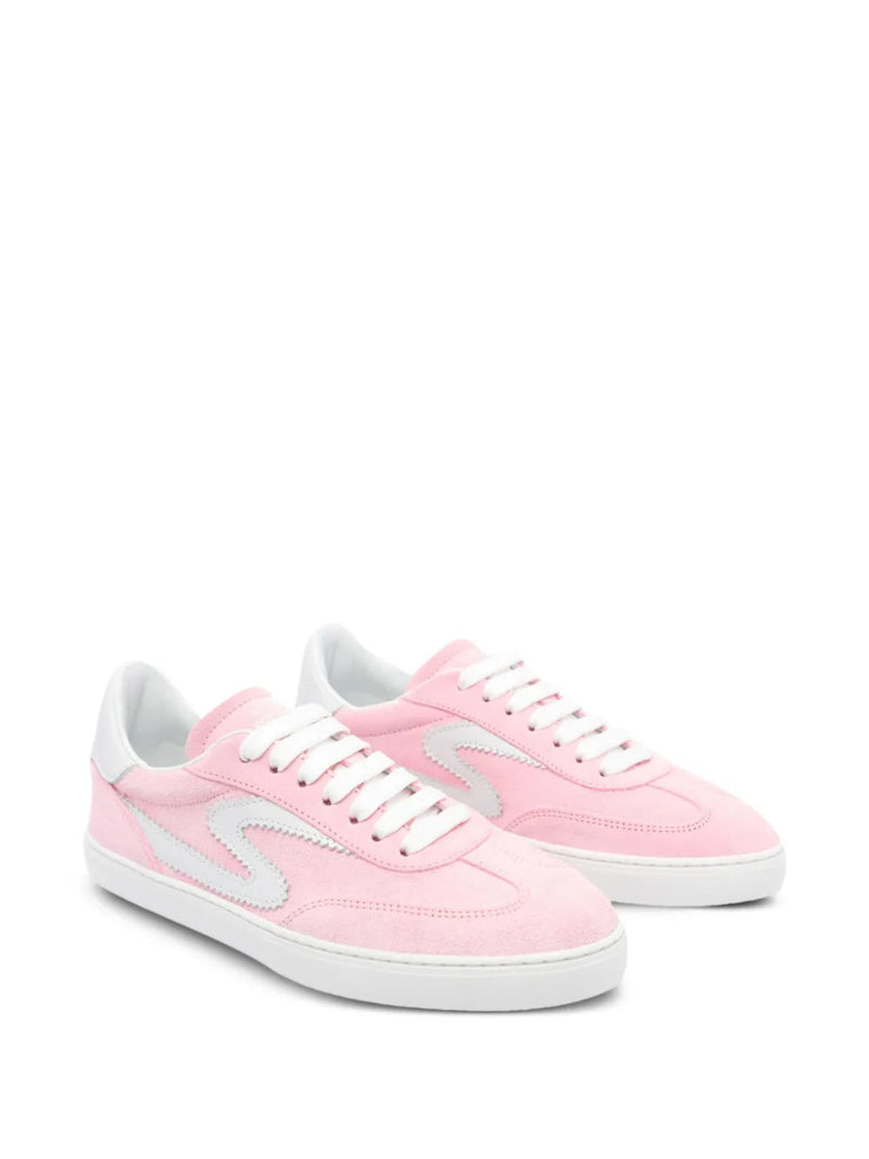 Pink sneakers with white laces on a white background