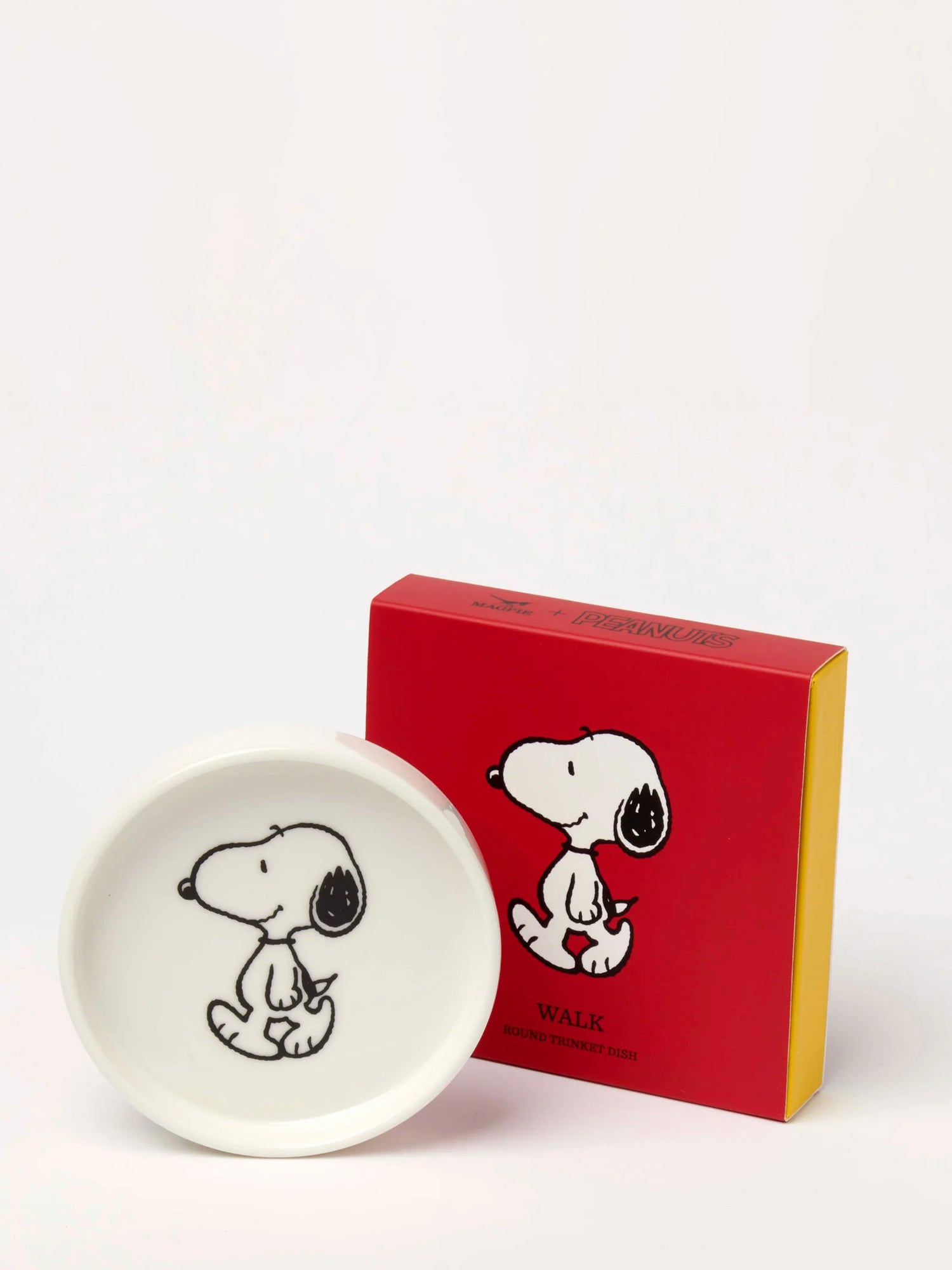 White dish with Snoopy dog illustration and red box with Snoopy on a white background