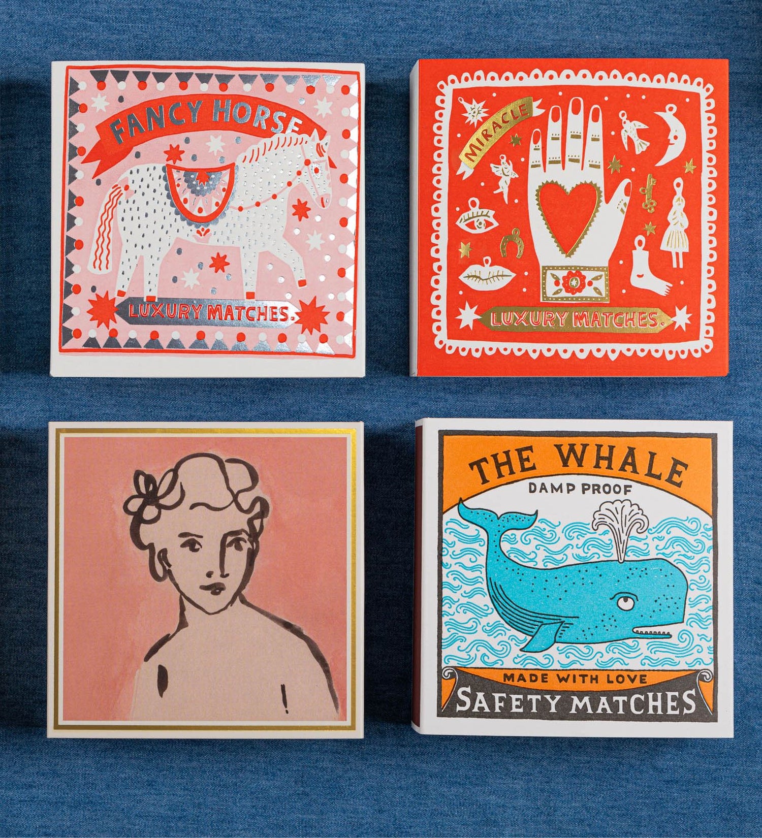 Four matchbox designs on a blue background