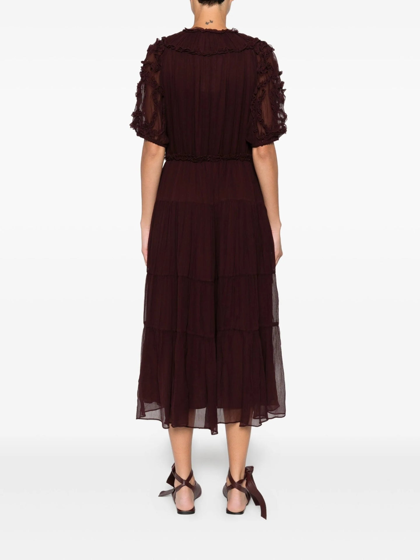 Burgundy dress with sheer sleeves on a white background