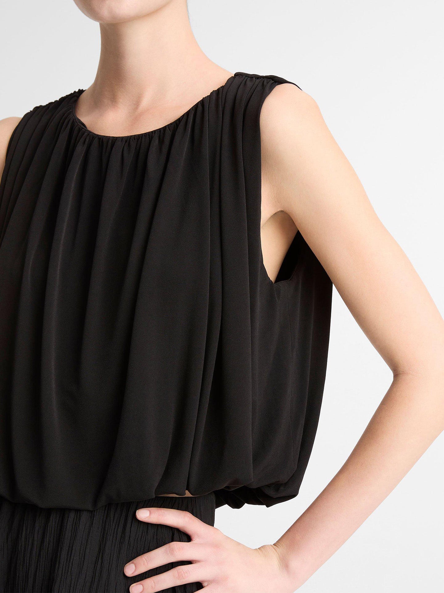 Black sleeveless bubble top and the armhole that shows the loose cut of this top by Vince.