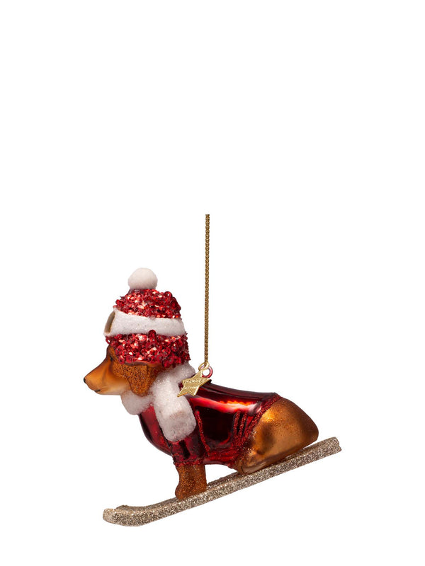 Dog on skis glass ornament