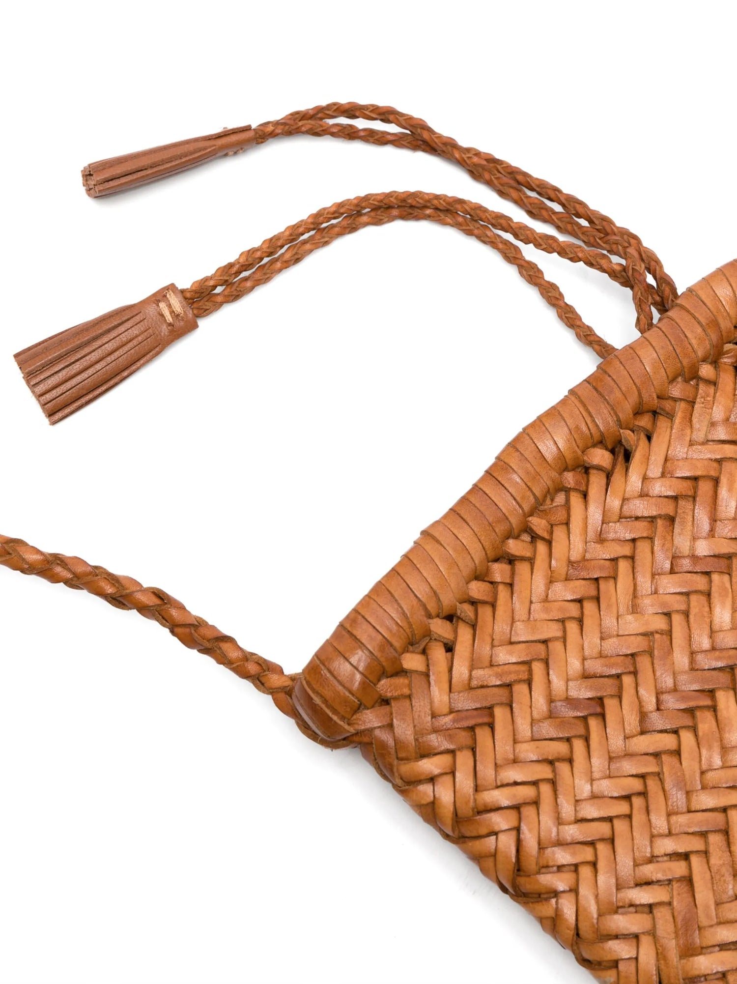 Close-up of a woven brown bag with tassels on a white background