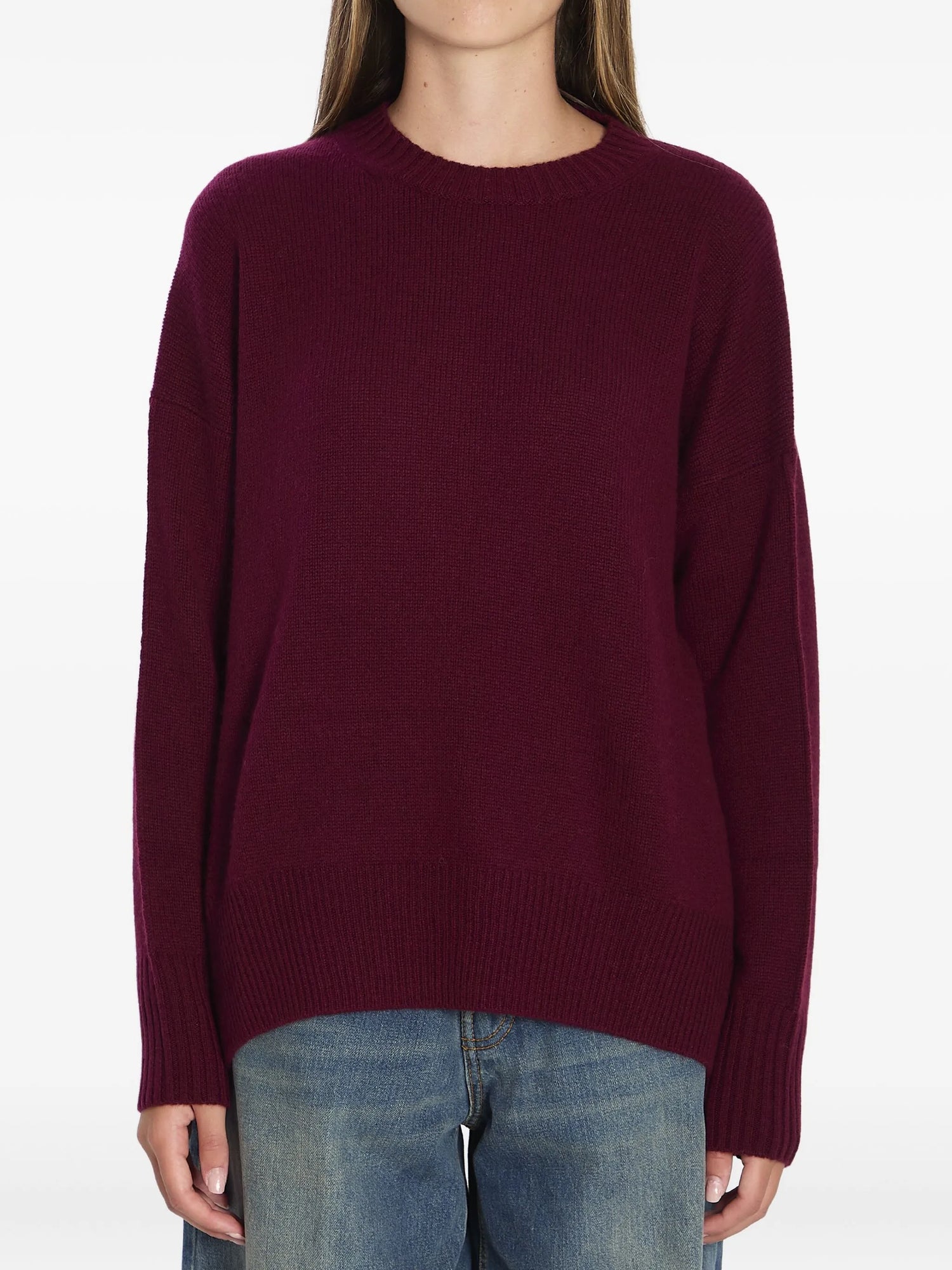 Maroon sweater worn by a person on a white background
