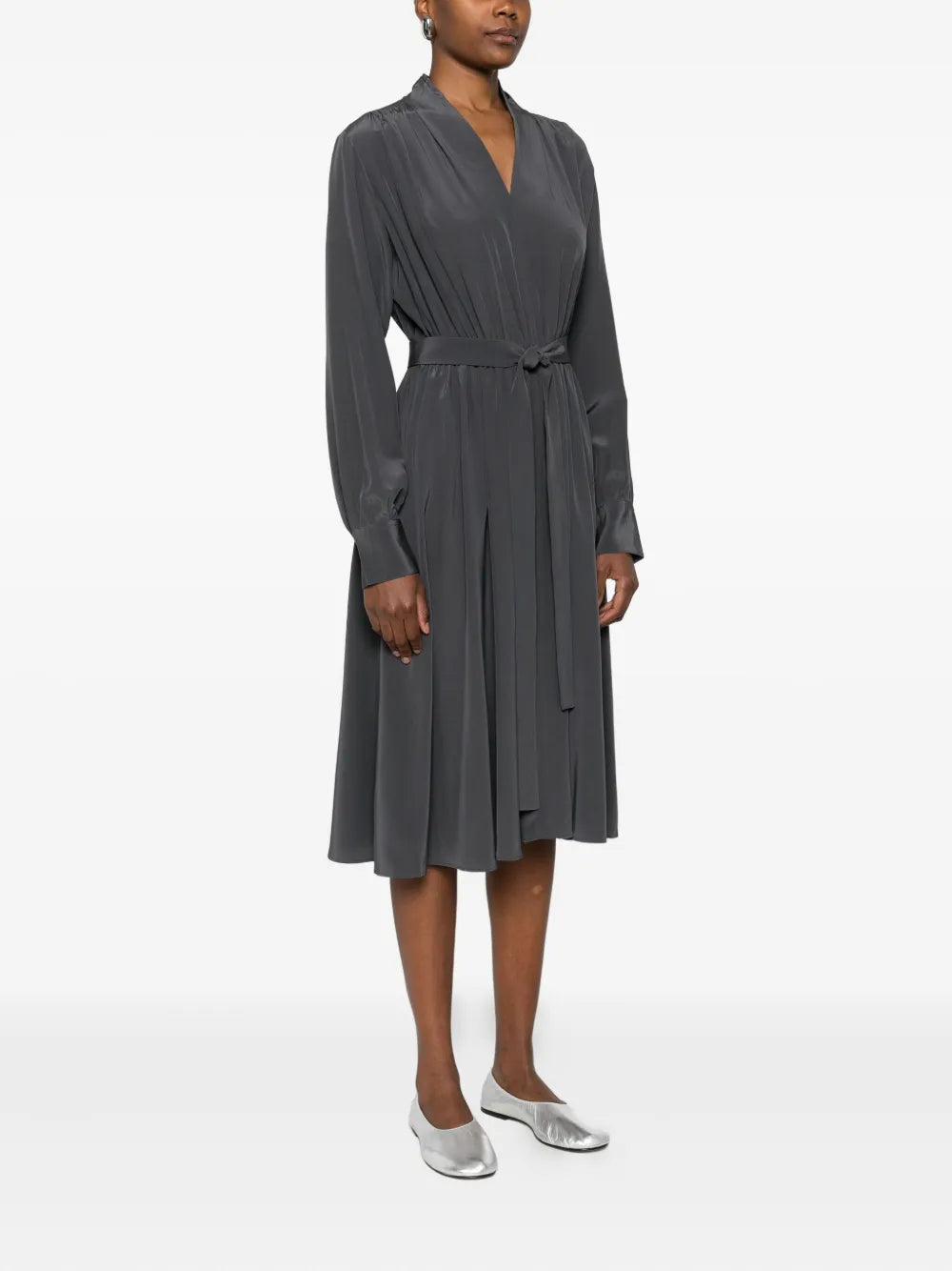 Woman wearing a gray dress on a white background