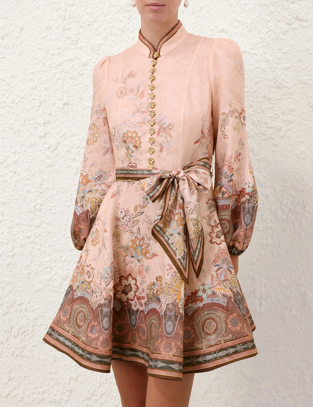 Floral patterned dress with a belt on a textured white background