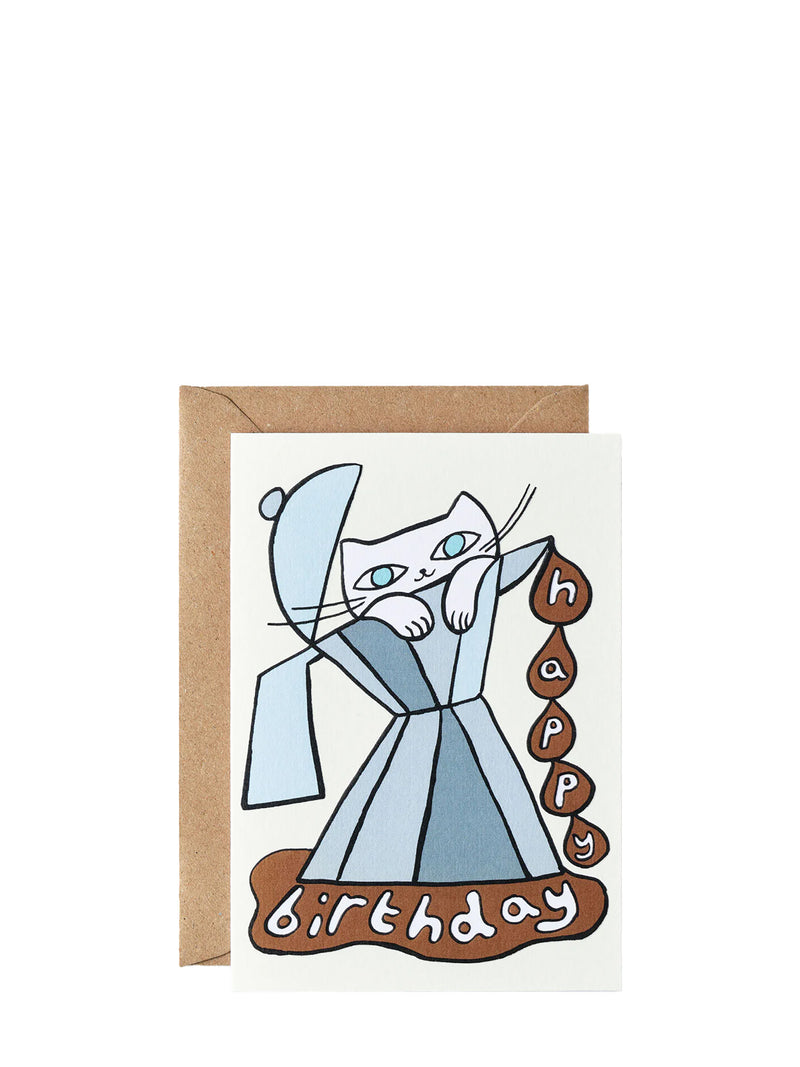 A greeting card with an illustration of a cat holding a coffee cup, with a 'Happy Birthday' text in bold letters. The card has a beige background and comes with a brown envelope.