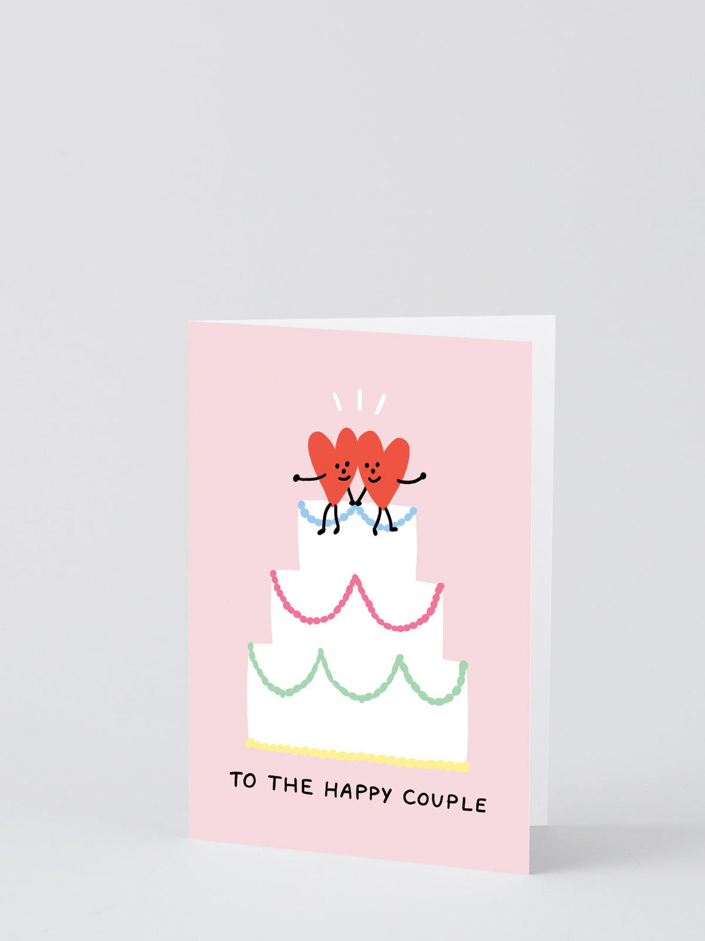 To The Happy Couple two hearts on cake wedding card