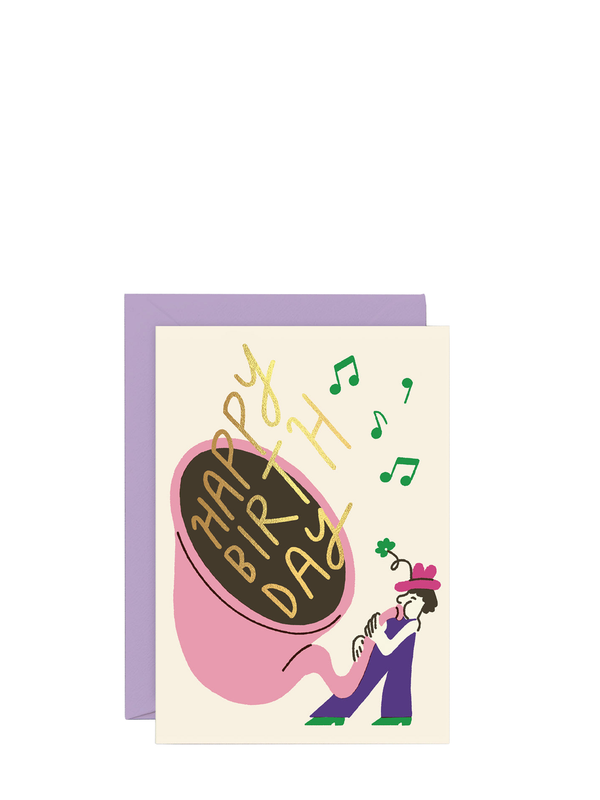 A birthday card featuring a musical theme with a large Tuba at the center, surrounded by musical notes, and a small figure of a person wearing a hat. The card is colorful with gold foil detailing.