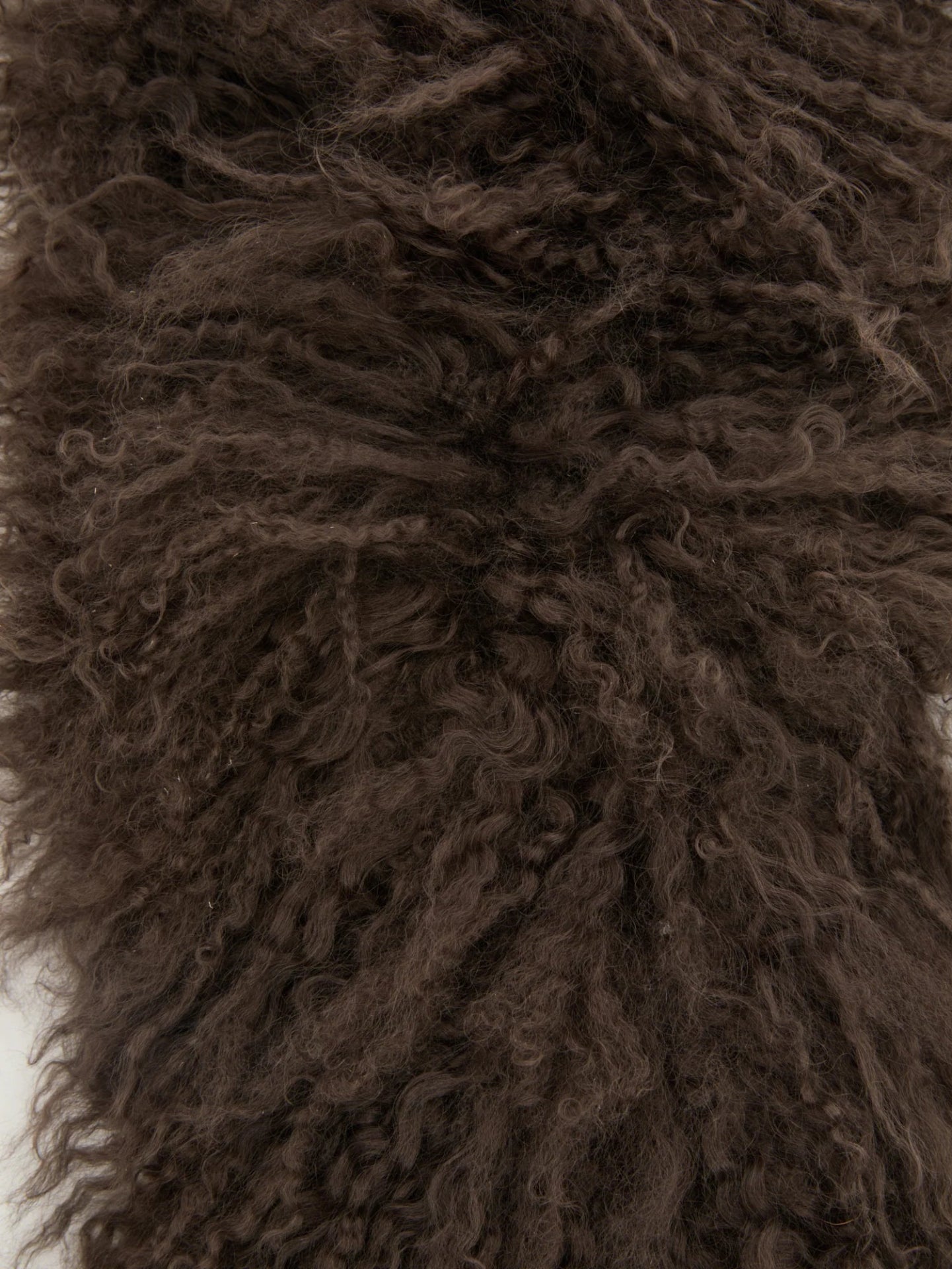 Close-up of brown, curly lamb hair texture scarf